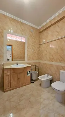 a bathroom with a toilet and a sink and a toilet istg at D'Água Brisa beachside apartment in Albufeira