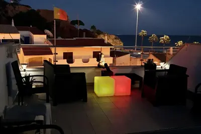 a view of a balcony with chairs and a light at Magnifique Duplex avec piscine en bord de mer in Olhos de Água