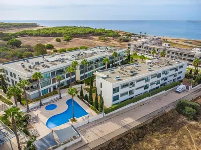 a bedroom with a bed with a large window at Quarteira Beach & Family Stay | Cavalo Preto in Quarteira