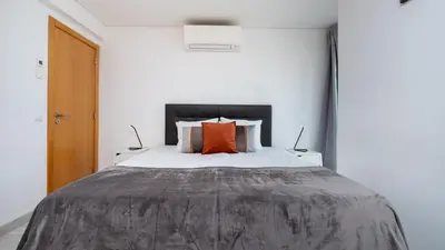 a bedroom with a large bed with two lamps at Vilamoura - Spacious with Swimming Pool & View in Vilamoura
