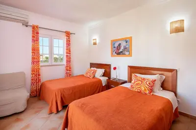a hotel room with two beds and a window at Private Villa Ribeiro I Heated Pool, 4 Bed, BBQ, AC, WIFI, BEACH in Albufeira