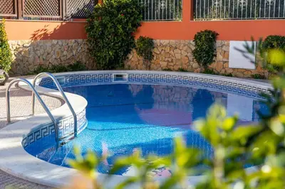 a swimming pool in front of a building at 4 Bed Private Villa Ribeiro II with heated pool, garden, wi-fi in Albufeira