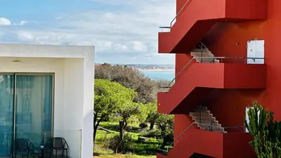 a red and white building with a view of the water at Bicos 7 by Check-in Portugal in Albufeira