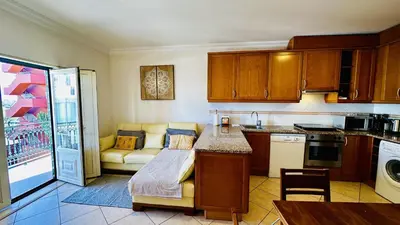 a kitchen with a couch and a table in it at Bicos 7 by Check-in Portugal in Albufeira