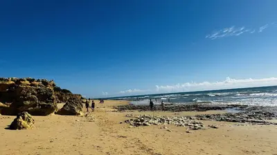 a group of people walking on the beach at Bicos 7 by Check-in Portugal in Albufeira