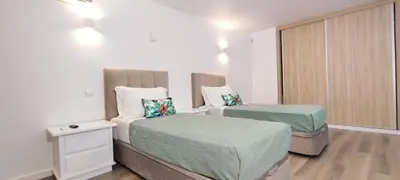 a small bedroom with two beds and a window at VTII & VTI 2 X Private Villas with pool and garden in Albufeira