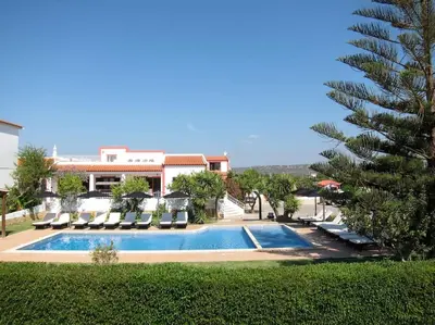 a swimming pool with lounge chairs and a palm tree at CH 7 - One Bedroom Apartment, Casa da Horta, Pool and Garden in Albufeira