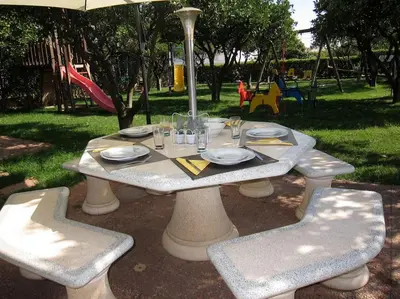 a picnic table with plates and glasses on it in a park at CH 7 - One Bedroom Apartment, Casa da Horta, Pool and Garden in Albufeira