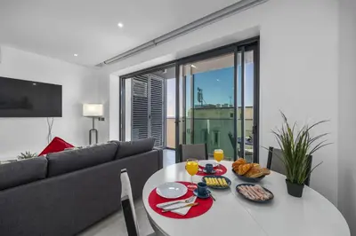 a living room with a table and a couch at Terracos de Quarteira 2 Red by Real Properties in Quarteira