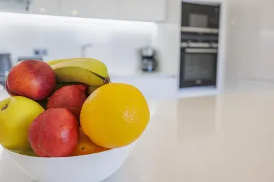 a bowl of fruit on a counter in a kitchen at Terracos de Quarteira 2 Red by Real Properties in Quarteira