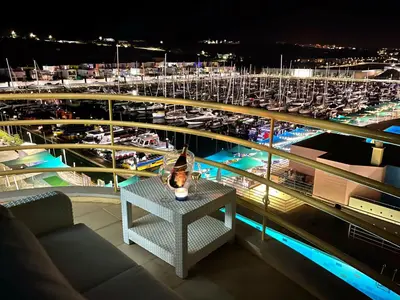 a group of colorful buildings and boats in a harbor at Apartment The LightHouse by Interhome in Albufeira