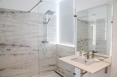 a bathroom with a sink and a shower at Villa Central By Garvetur in Quarteira