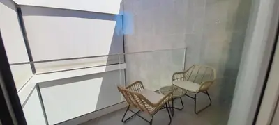 a balcony with two chairs and a table at Villa Central By Garvetur in Quarteira
