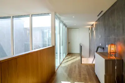 a room with a large window and a desk with a lamp at Villa Central By Garvetur in Quarteira