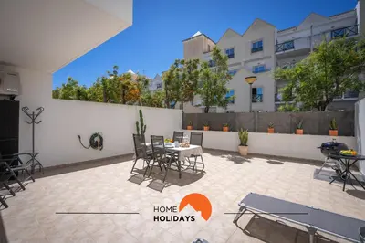 a patio with a table and chairs and a building at #194 Dream Flat by Home Holidays in Albufeira