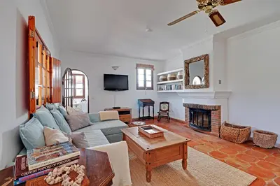 a living room with a couch and a fireplace at Quinta Grande de Boliqueime by Portucasa in Boliqueime