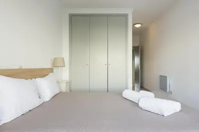 a bedroom with a large bed with white pillows at Terracos Falesia II - Terrace with pool by HD in Vilamoura