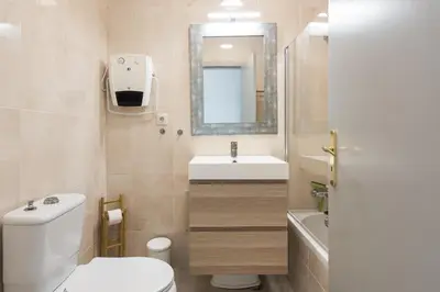 a bathroom with a toilet and a sink and a mirror at Terracos Falesia II - Terrace with pool by HD in Vilamoura