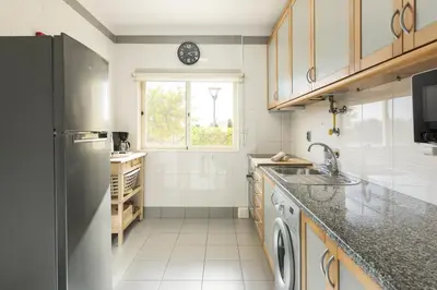 a kitchen with a sink and a refrigerator at Terracos Falesia II - Terrace with pool by HD in Vilamoura