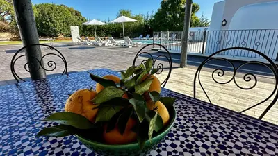 a bowl of oranges sitting on a table on a table sidx sidx at Mourisca by Check-in Portugal in Vilamoura