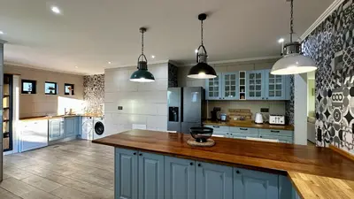 a kitchen with blue cabinets and a wooden counter top at Mourisca by Check-in Portugal in Vilamoura