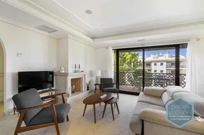 a living room with a couch and a tv at Rooftop 27 - Dream Lodging in Albufeira