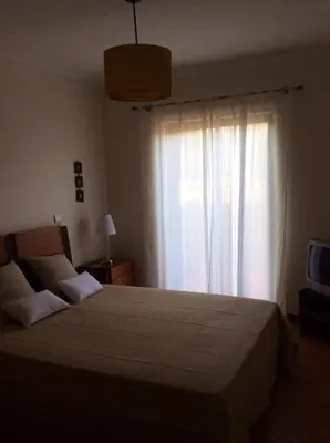 a bedroom with a large bed with a window at Vila Bairos Apartment Vilamoura in Vilamoura