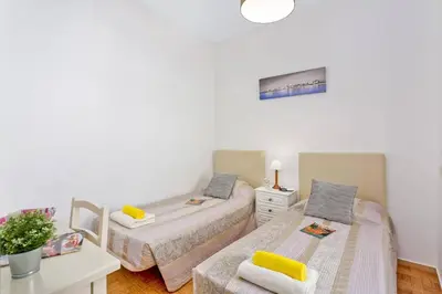 a bedroom with two beds and a desk with a table at Villa Carlos by Villa Plus in Galé