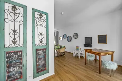 a living room with a table and a chalkboard at Villa Casa Duarte by Villa Plus in Olhos de Água