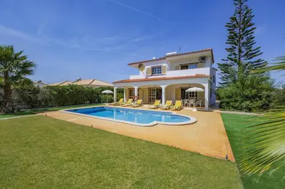 a house with a swimming pool in the yard at Villa Casa Lourenco by Villa Plus in Albufeira