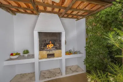 a fireplace in a house with a man in it at Villa Casa Lourenco by Villa Plus in Albufeira