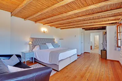 a bedroom with a bed and a couch at Quinta Boliqueime by Portucasa in Boliqueime