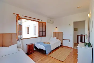 a bedroom with two beds and a window at Quinta Boliqueime by Portucasa in Boliqueime