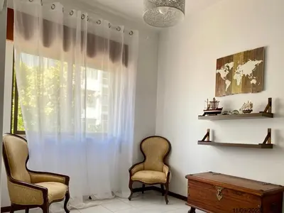 a living room with two chairs and a window at Blife Anya private rooms in Faro