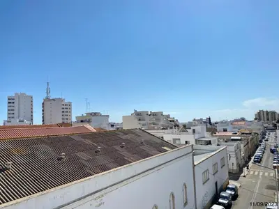 a view of a city from the roof of a building at Blife Anya private rooms in Faro