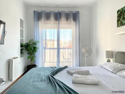 a white bedroom with a large bed with a window at Blife Anya private rooms in Faro