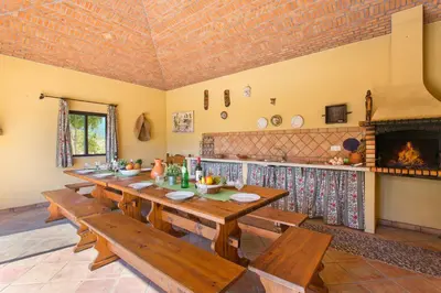 a dining room with a table and a fireplace at Villa Karlia by Villa Plus in Galé