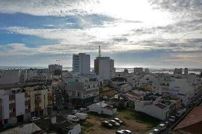 a view of a city with buildings and cars at Blife Chelsya private rooms in Faro