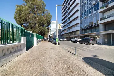 a street with cars parked on the side of the road at Casa Alameda in Faro