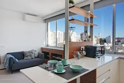 a kitchen and living room with a view of a city at Casa Alameda in Faro