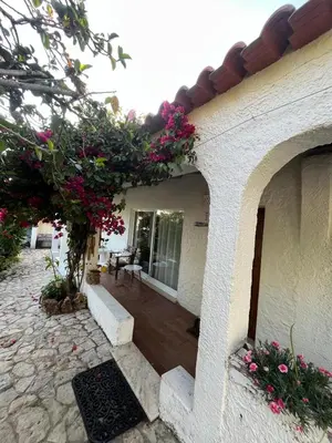 a kitchen with a bed and a table in a room at Lugar das Andorinhas in Olhos de Água