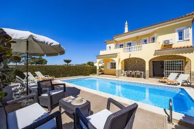 a villa with a swimming pool and a house at Villa Graca by Villa Plus in Albufeira