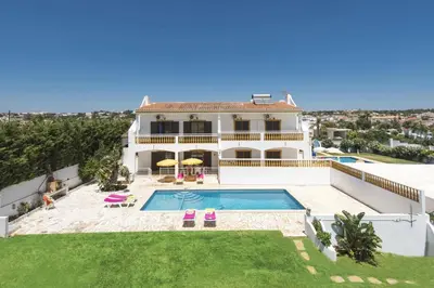 a large white house with a swimming pool in a yard at Villa Luis Gale by Villa Plus in Galé