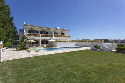 a villa with a swimming pool and a yard at Villa Luis Gale by Villa Plus in Galé