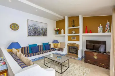 a living room with a couch and a fireplace at Villa Tadeu Quatro by Villa Plus in Azinhal