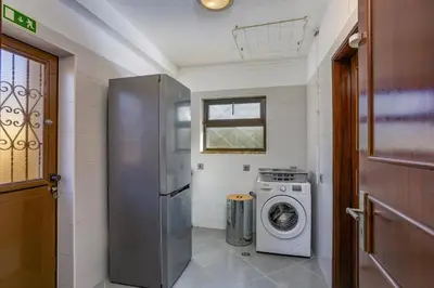 a kitchen with a refrigerator and a washing machine at Villa Tadeu Quatro by Villa Plus in Azinhal