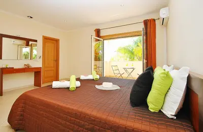 a bedroom with a large bed with pillows at Villa Anna by Algarve Vacation in Albufeira