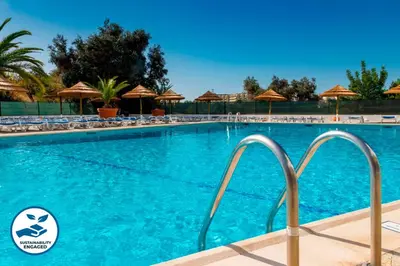 a swimming pool at a resort with chairs and umbrellas at Apartment Atlantic Sea by Algarve Vacation in Albufeira