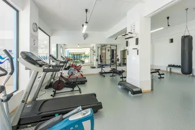 a gym with treadmills and machines in a room at Apartment Atlantic Sea by Algarve Vacation in Albufeira