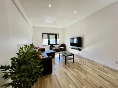 a living room with a couch and a tv at Albufeira Central 7 by Homing in Albufeira